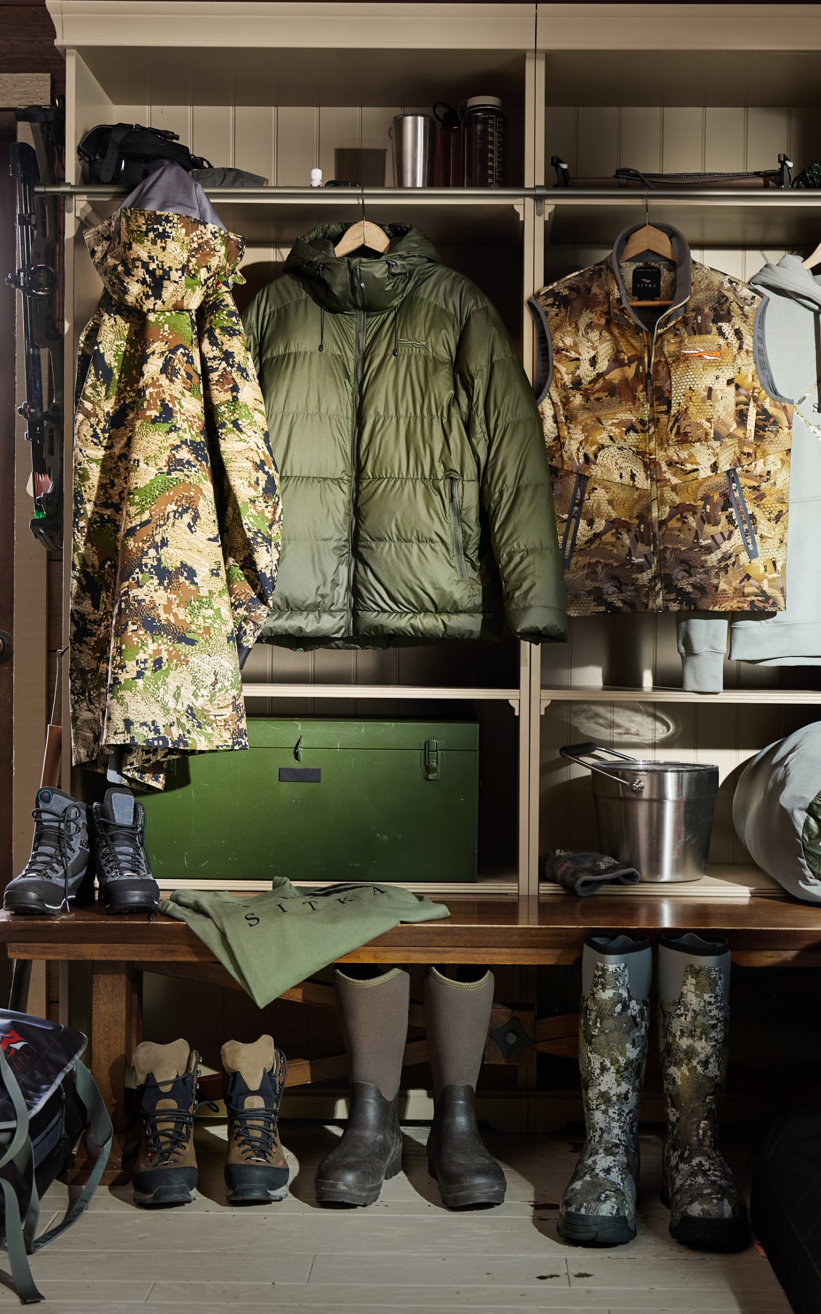 Jackets, vests and gear hung in a mud room | SITKA Holiday Gift Guide