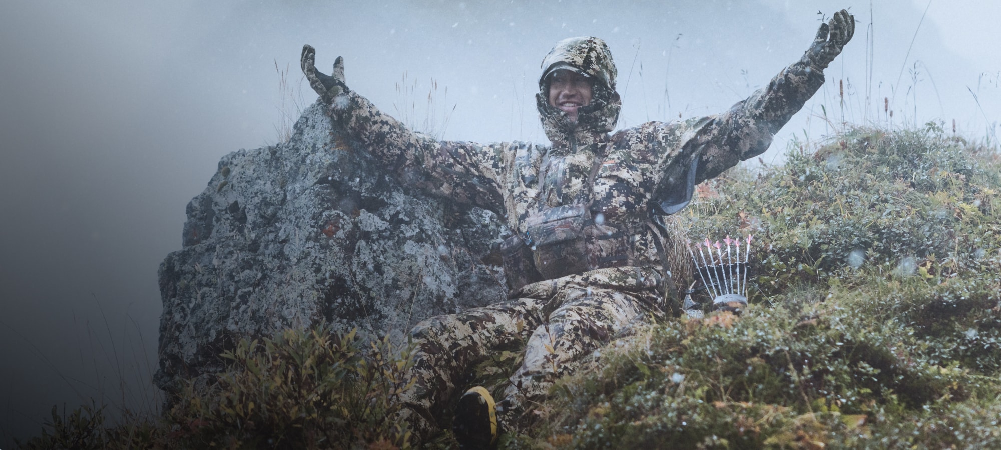 Paul Forward embracing the rain in the Dew Point Jacket and Pant in Optifade Subalpine | SITKA Gear Holiday Gift Guide