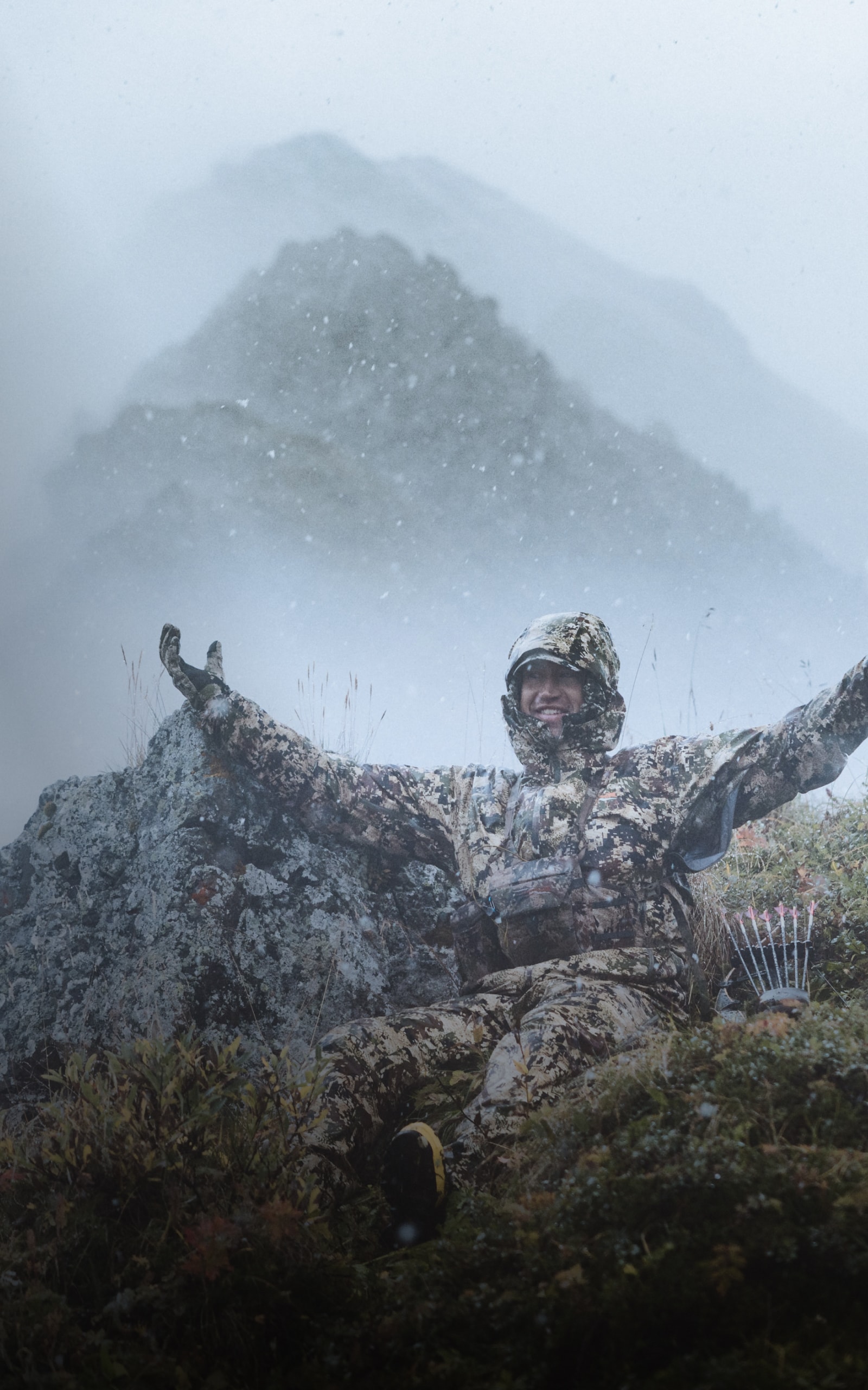 Paul Forward embracing the rain in the Dew Point Jacket and Pant in Optifade Subalpine | SITKA Gear Holiday Gift Guide