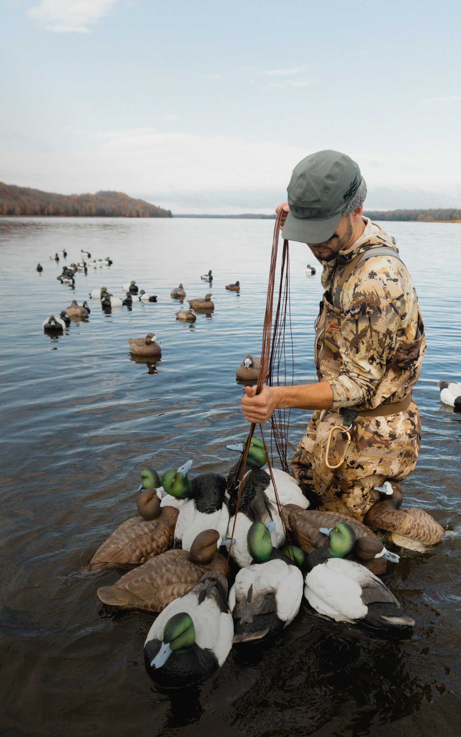 Man setting up the decoy spread in the Delta Zip Wader in Waterfowl Marsh | SITKA Gear