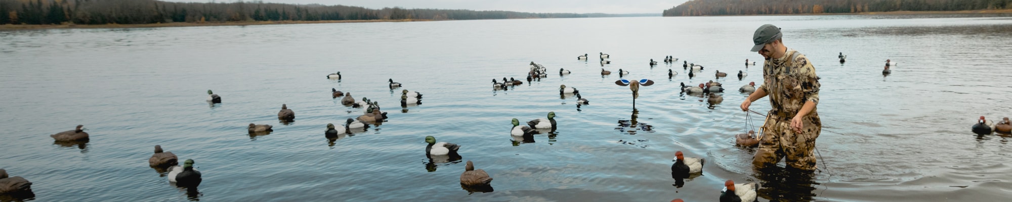 Man setting up the decoy spread in the Delta Zip Wader in Waterfowl Marsh | SITKA Gear