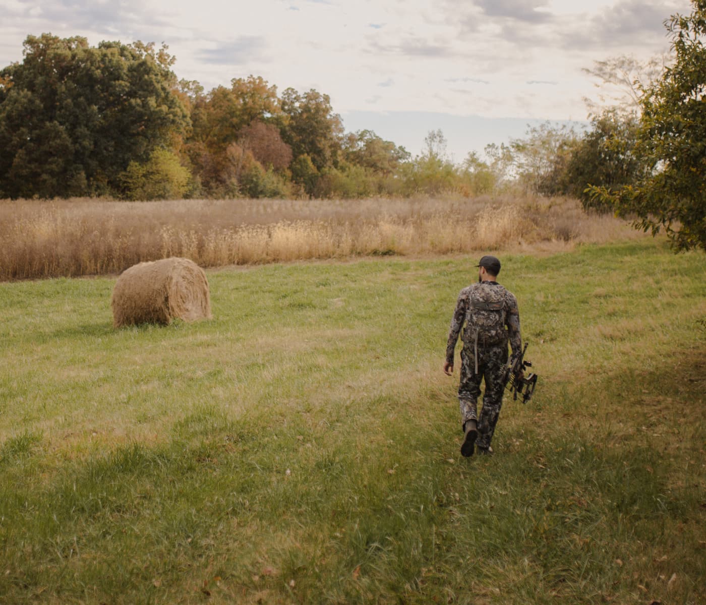 Man walking to his treestand on a field edge | SITKA Gear